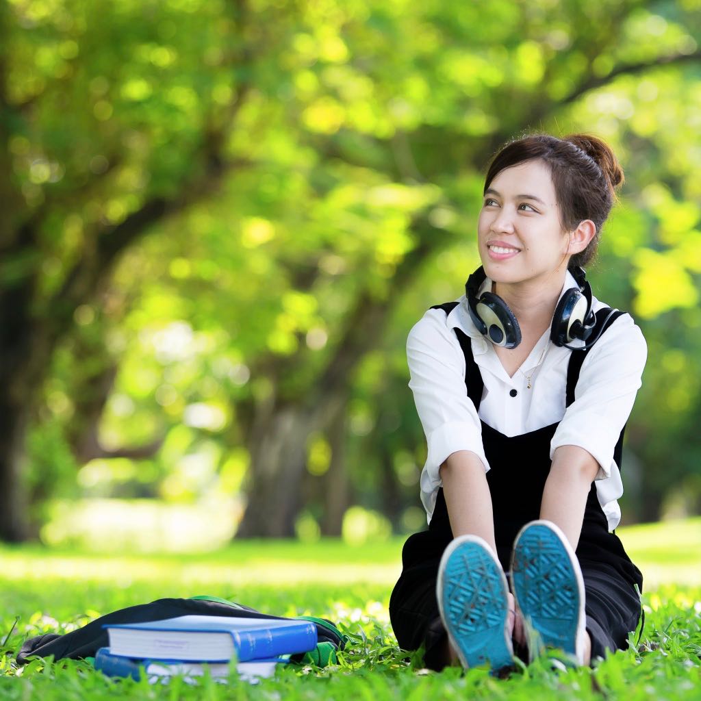 Student sitting in scenic campus